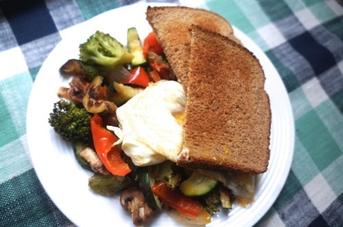 Leftover Veggies & an Egg with Toast in a plate over a checkered table cloth