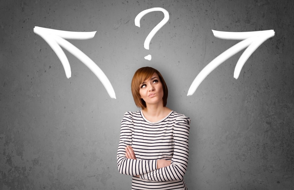 Young woman taking a decision in gray background