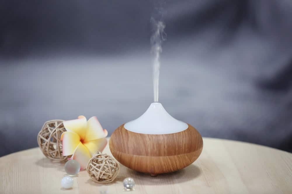 Spa concept. Aroma oil diffuser on table against blurred background