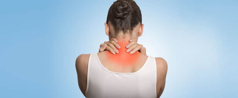 Young woman holding her nape with both hands due to pain.