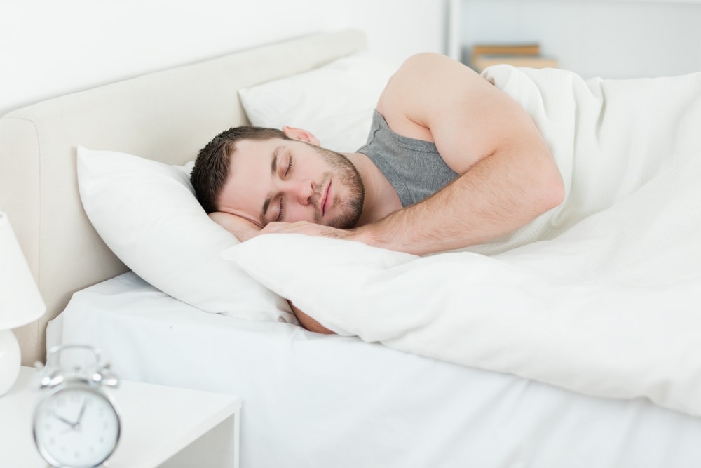 Serene man sleeping in his bedroom