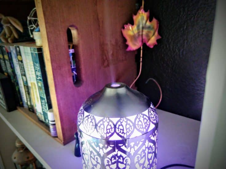 A diffuser turned on with a lavender light