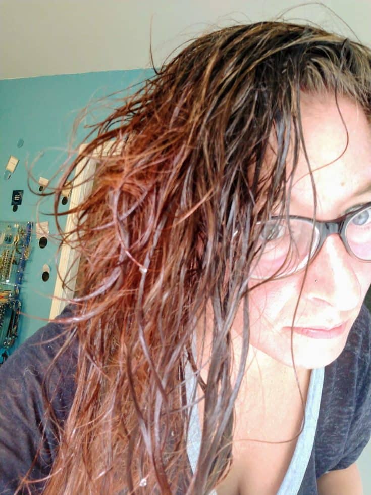 a close up shot of a woman with rinsed hair from a cold water