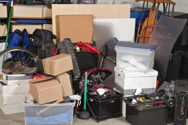 Pile of boxes junk inside a residential garage.