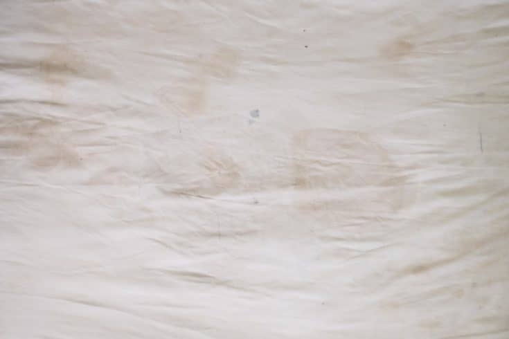 Body oil stains,odors and stains,other dirt on white bedding sheet,unclean bed sheet