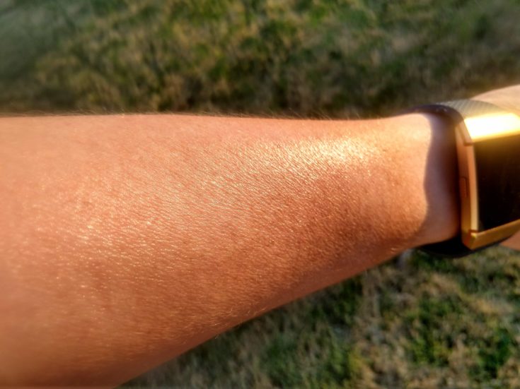 A close up shot of an arm with a watch and a direct sunlight on it