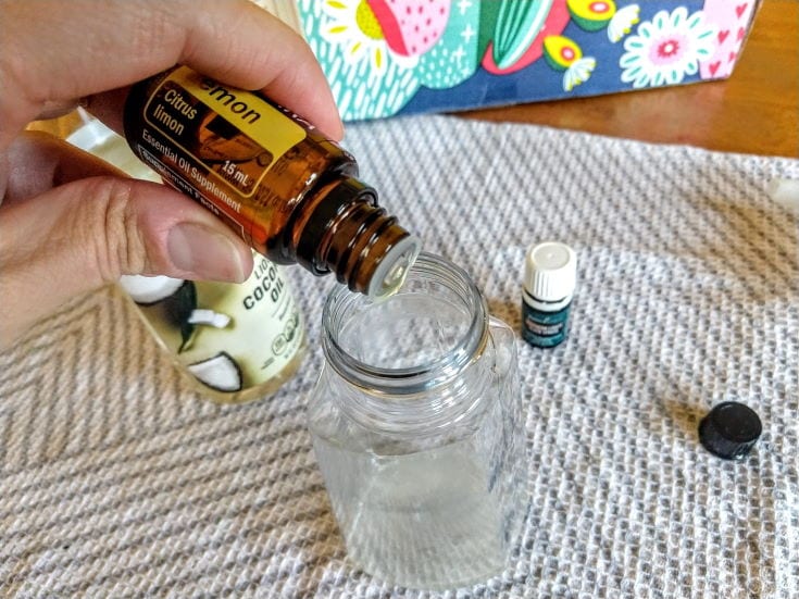 Person's hand put essential oil on the bottle