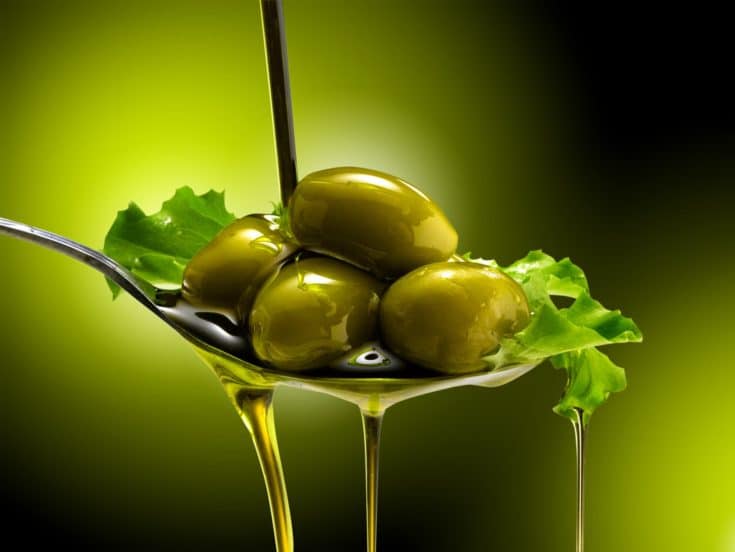 Olive oil spilling on a spoon