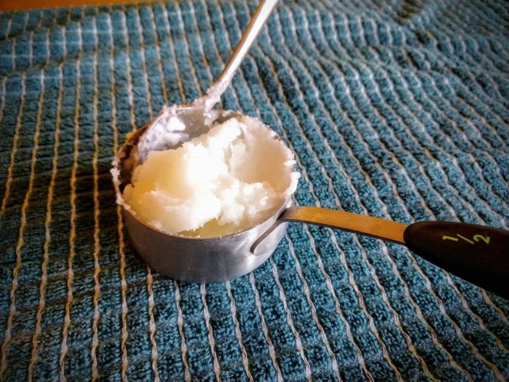 adding fractionated coconut oil into the measurement cup