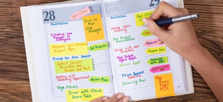 woman writing on journal notebook